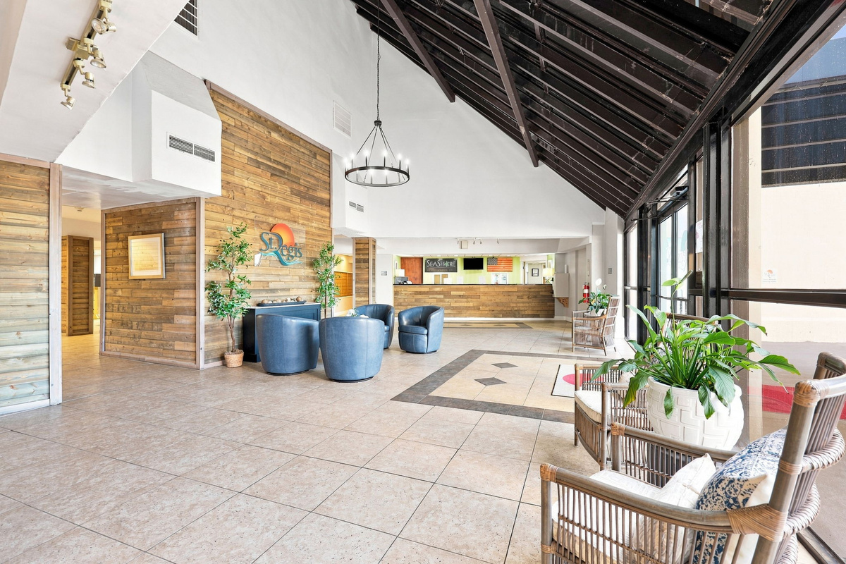 Welcoming resort lobby and lounge area featuring wood-paneled walls, comfortable seating, and a bright, airy atmosphere.