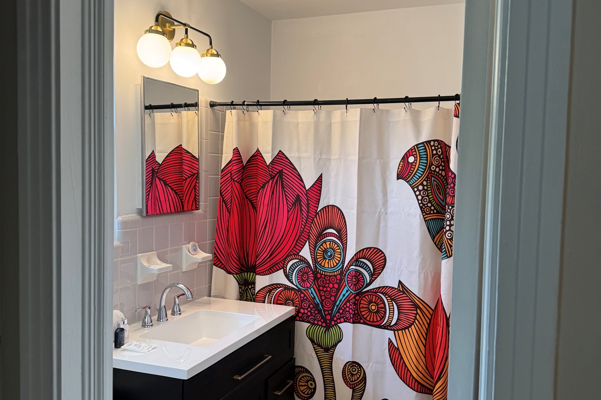 Bathroom has tub/shower combo and a large vanity for all your things.