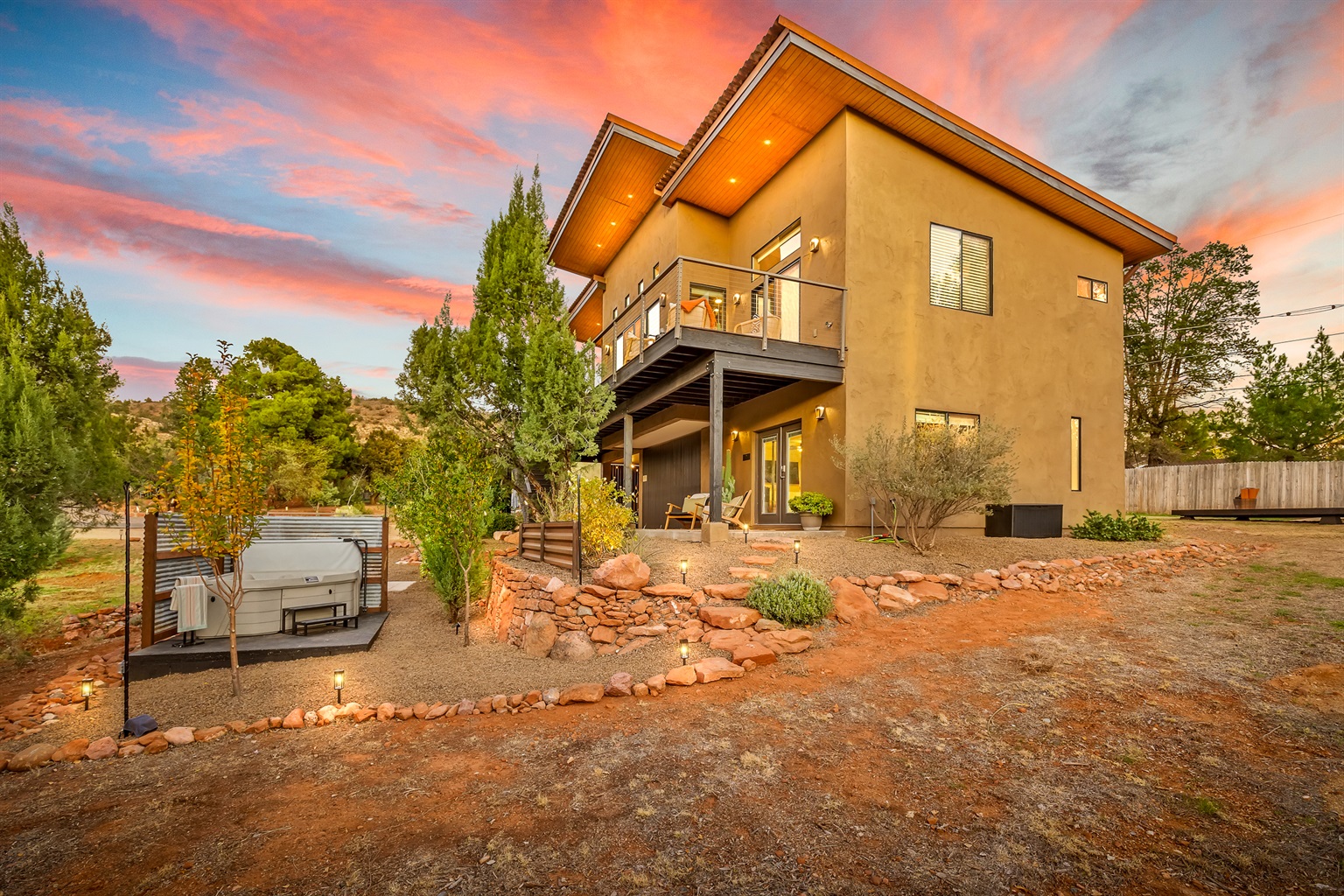 Romantic Sedona guesthouse nestled beneath the main home, featuring a private 2-person hot tub, desert landscaping, and iconic red rock sunset views. 