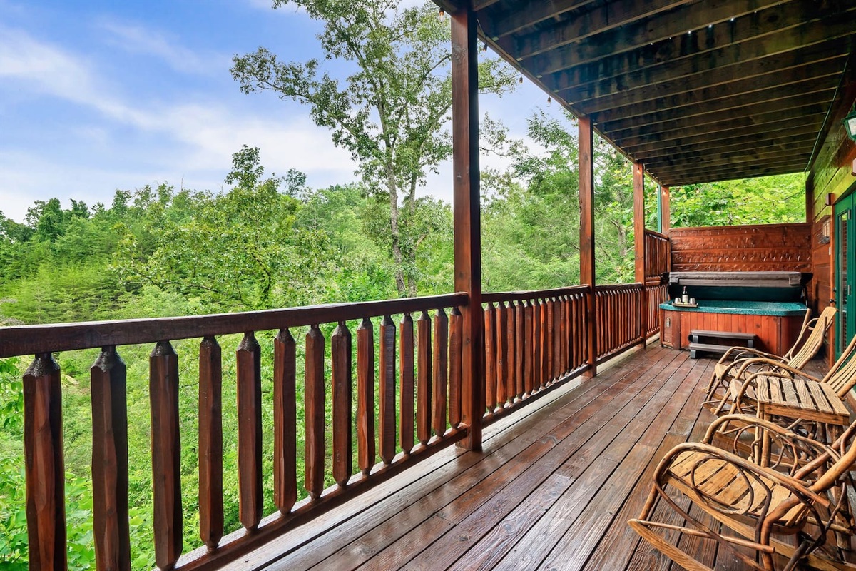 Private hot tub is located on lower level porch, with plenty of room for a game of cornhole