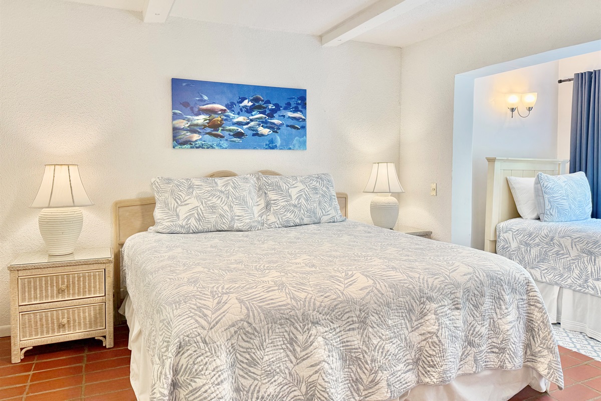 Guest bedroom with queen and twin beds, ceiling fan and bathroom