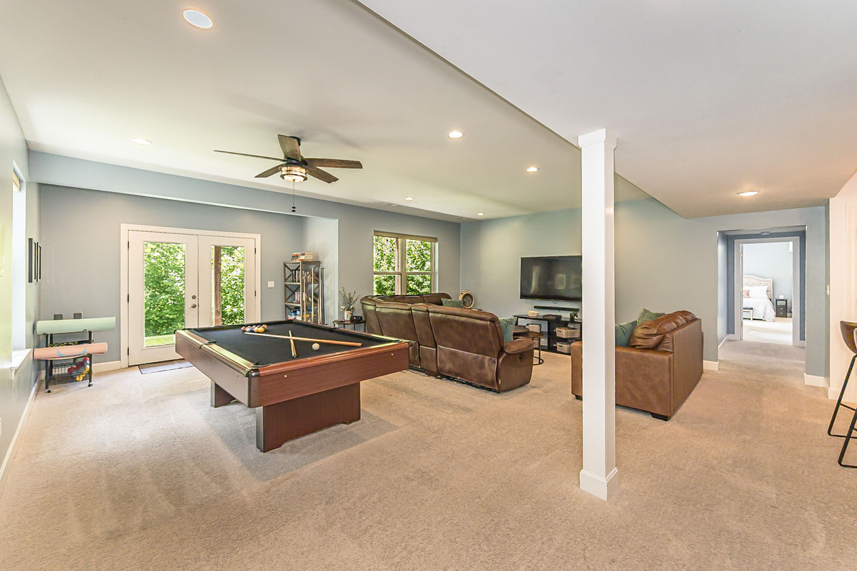 The lower-level game room offers plenty of space to spread out and has 9-foot ceilings.