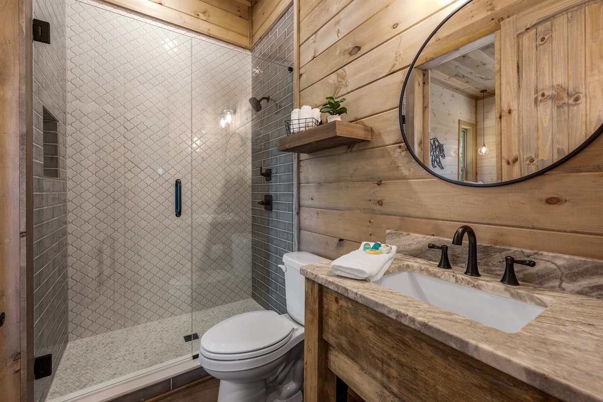 The main level suite has a full bathroom, complete with a rain head shower. 