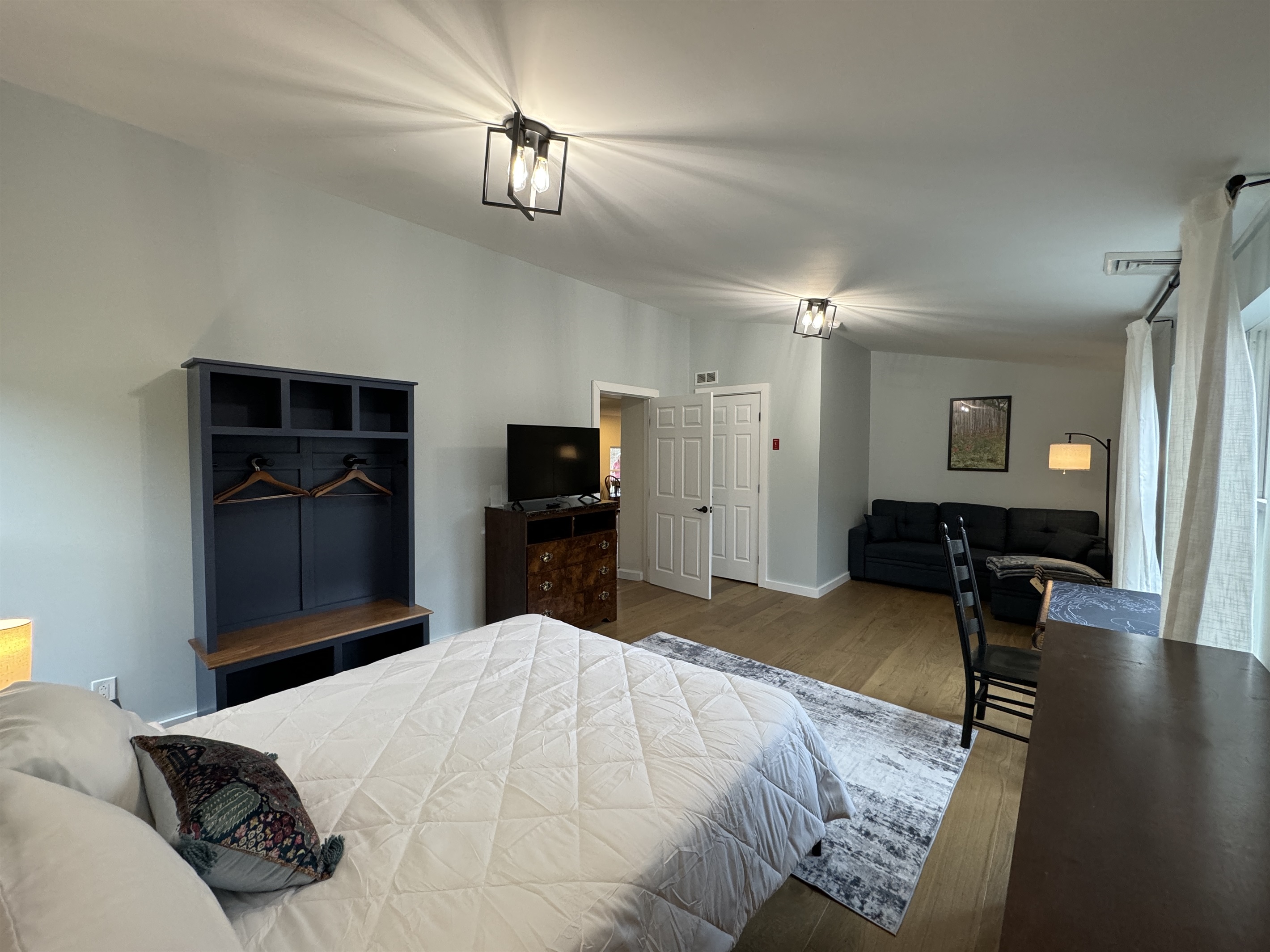 Primary Queen bedroom with desk and lounge area