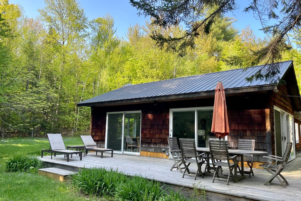 Wraparound deck with dining space and lounge area