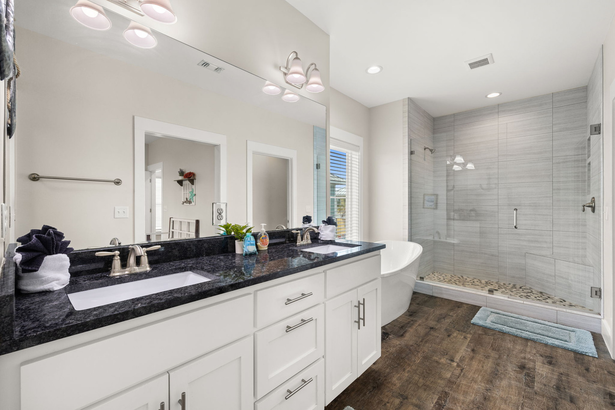 Second-floor master bathroom featuring large soaking tub, walk-in shower & double vanity