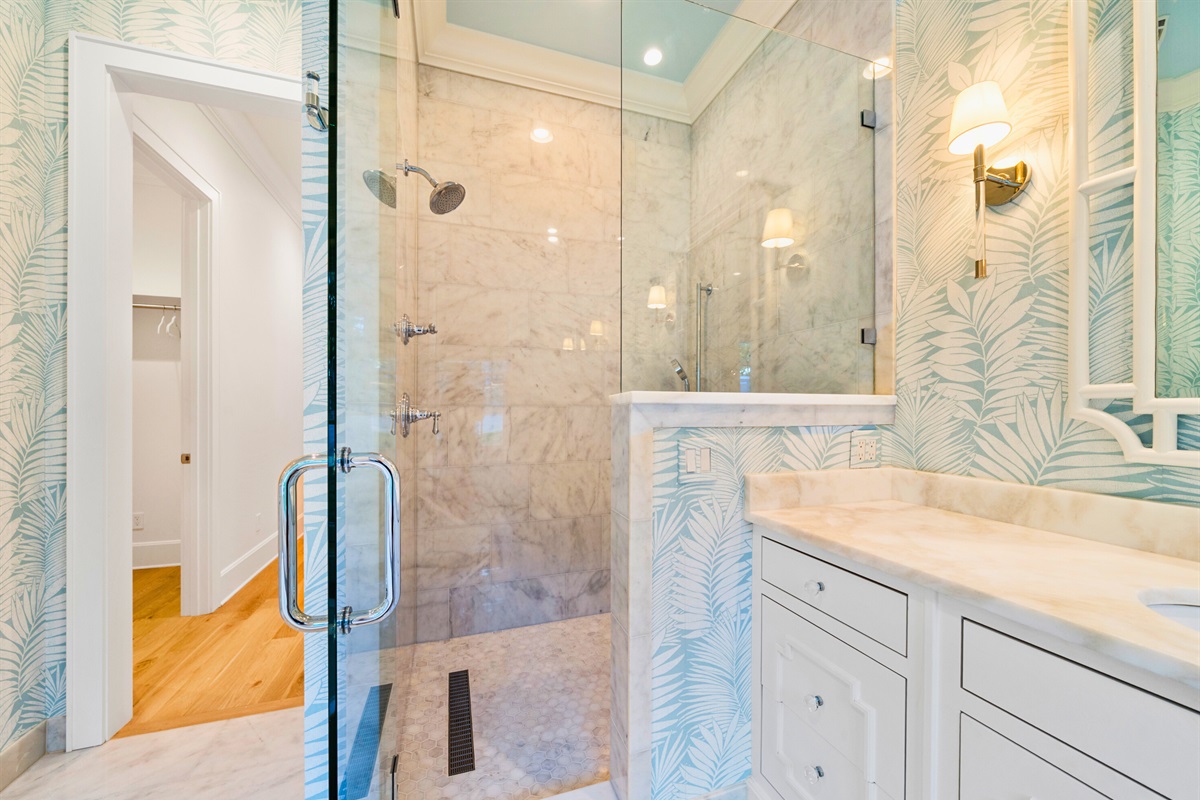 Luxury bathroom featuring dual vanities and walk-in shower.