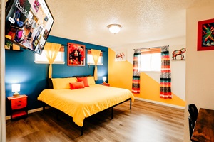 Wake up in a room where cheerful yellow bed linen meets a harmonious yellow and white wall, accented by a curtain bursting with colors. This vibrant sanctuary brings joy, energy, and a dash of playfulness to the start of each day.