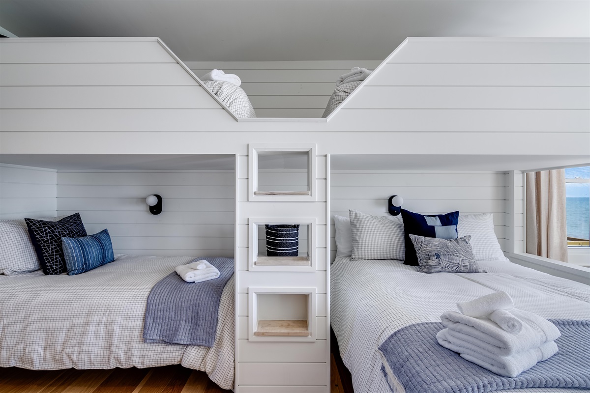 Bedroom with 3 twins, and 1 Queen bed. 