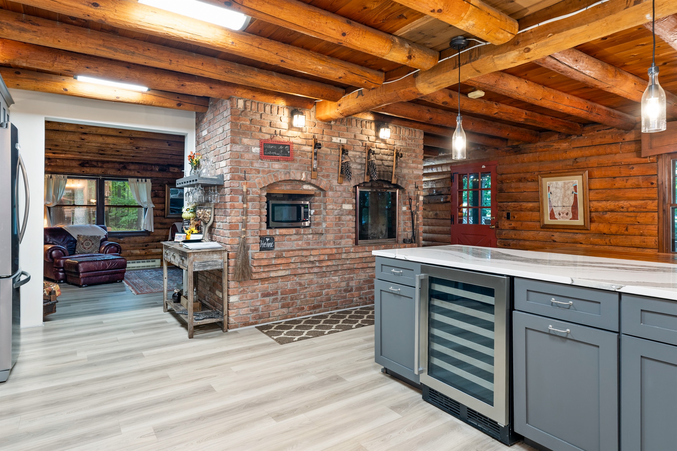A modern chef’s kitchen with sleek gray cabinetry, wine cooler, and spacious island blending style with convenience.