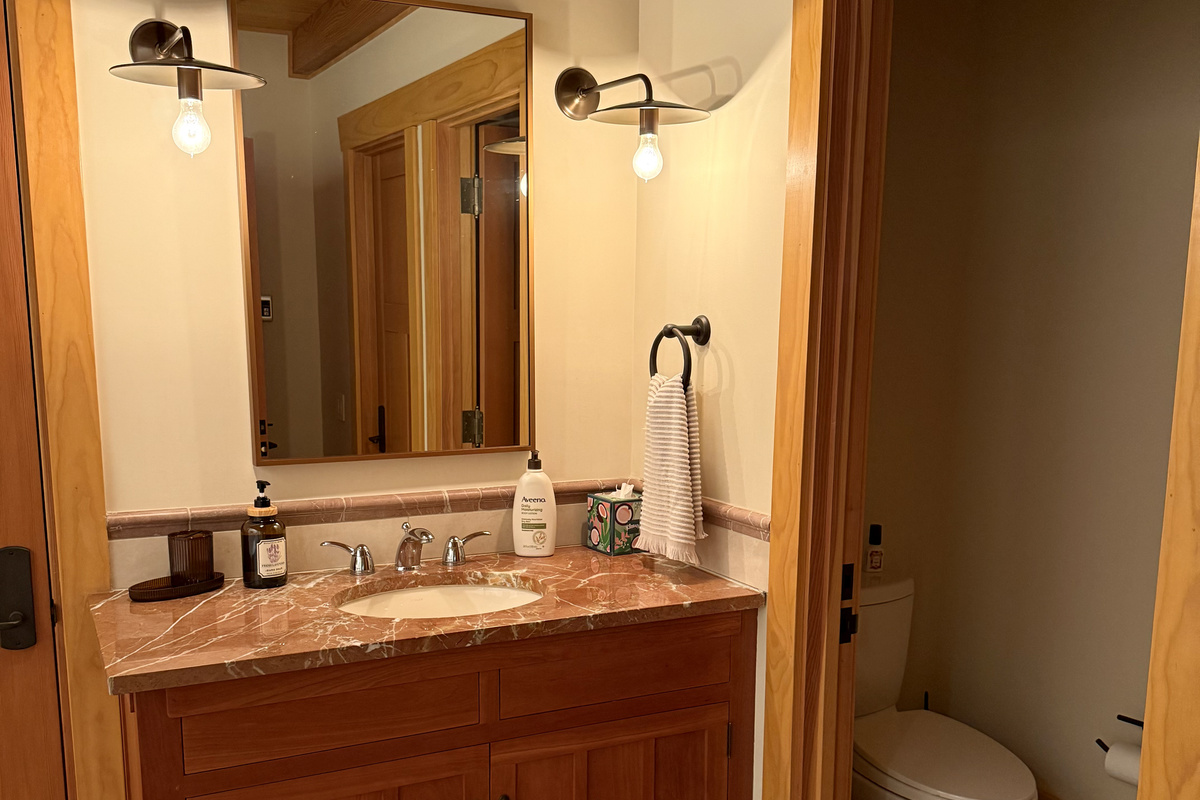 The carriage house includes its own private bathroom, separate from the main house, with a soaking tub and a large walk-in shower for added comfort.