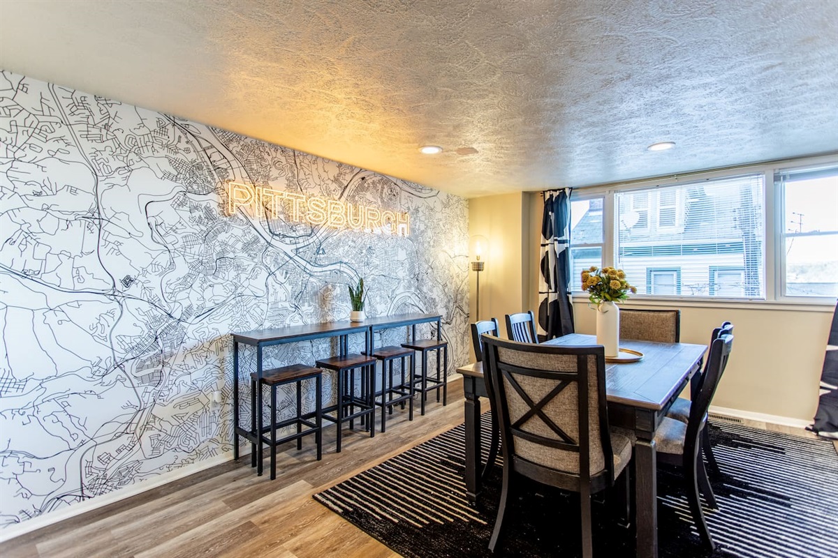A stylish 6-seater dining table set against a backdrop of neutral tones, featuring modern chairs and a simple centerpiece for an intimate dining experience.