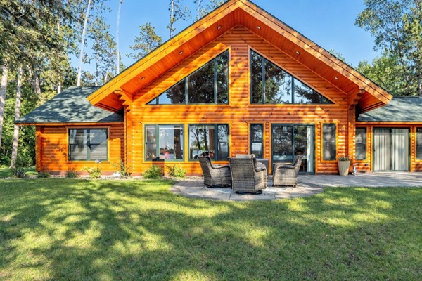 Spacious new home that feels like a modern log cabin retreat with private patio, lake access, forest views, and room for the whole family