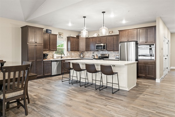 Fully stocked Kitchen has (2) dishwashers, (1) microwave, slide in range with oven, (1) wall oven, large refrigerator/freezer with ice maker. The island seats four.