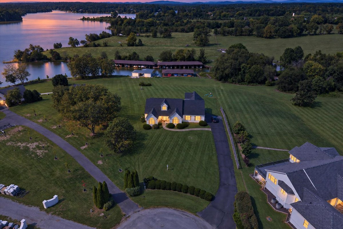 Aerial view showcasing the home’s spacious lot, waterfront setting, and private boathouse.