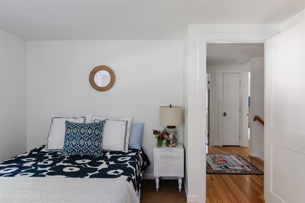 Spacious third bedroom with a queen bed, perfect for  additional guests.