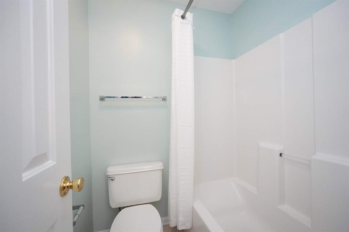 Toilet and Tub/Shower with door for privacy from vanity area