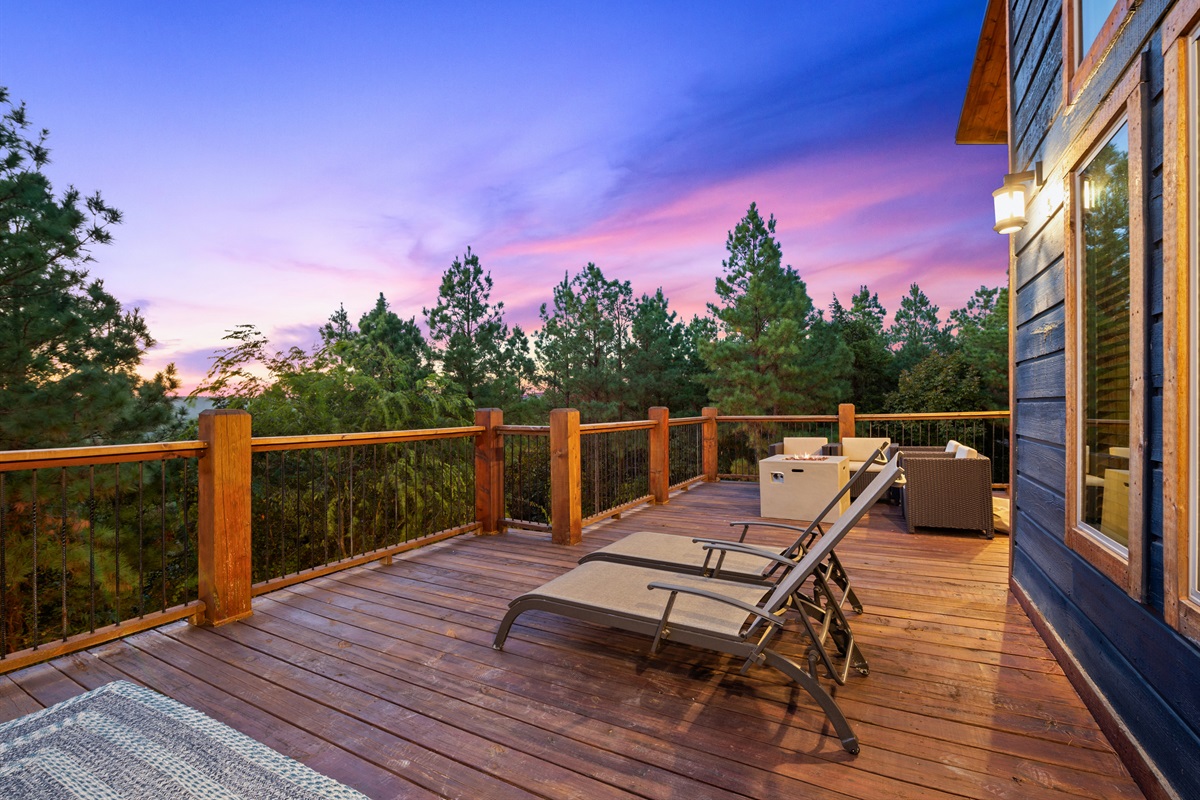 Whether dining outdoors or simply relaxing, this spacious deck offers ample seating and incredible forest views.
