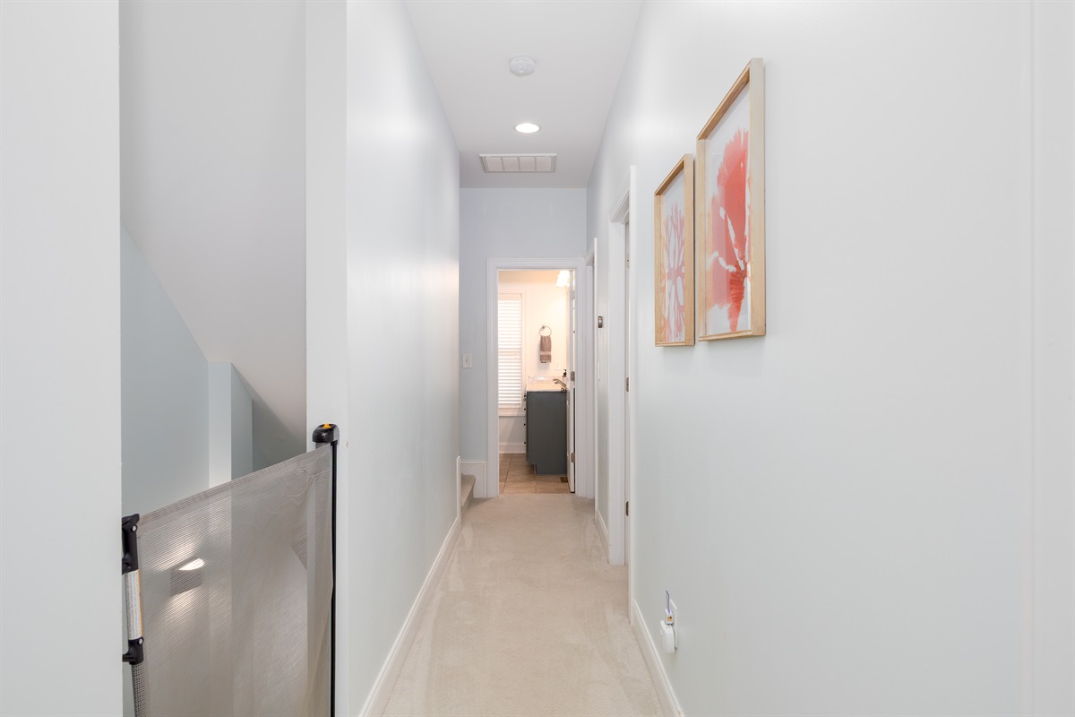 The hallway features a child safety gate