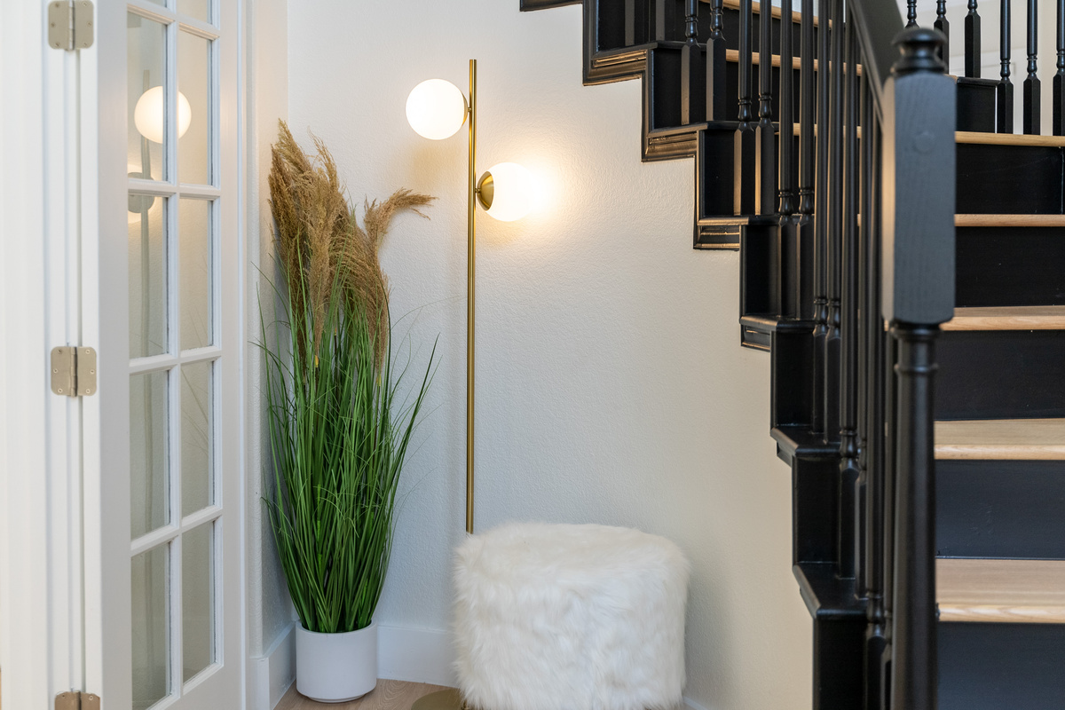 French doors frame a cozy corner, blending indoor comfort with garden views.