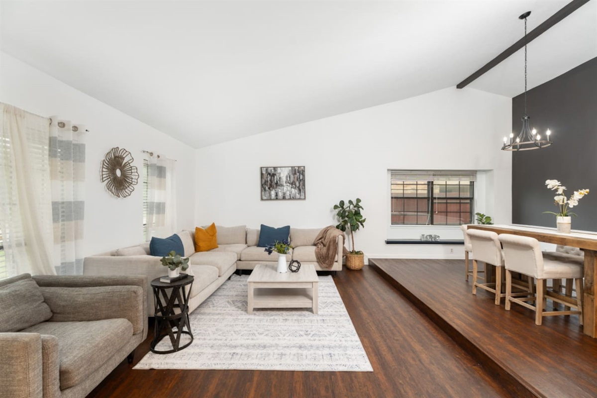 Modern living space with open floor plan to the kitchen.