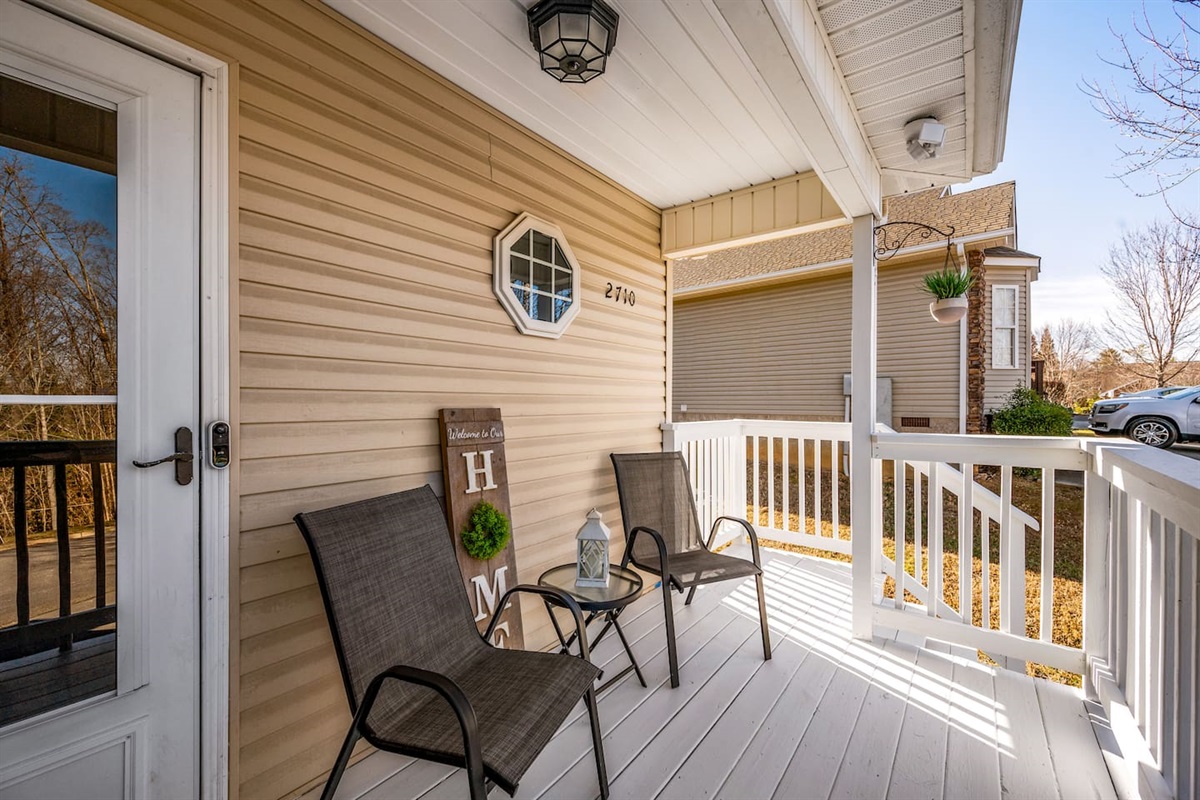 Charming front porch with cozy seating, perfect for enjoying your morning coffee or relaxing in the fresh air.