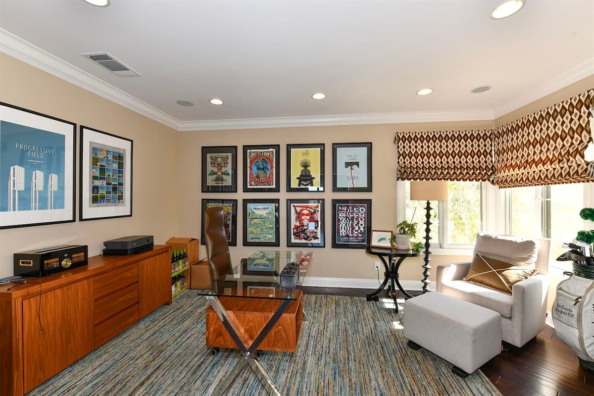 Office with desk, chair, and fireplace.