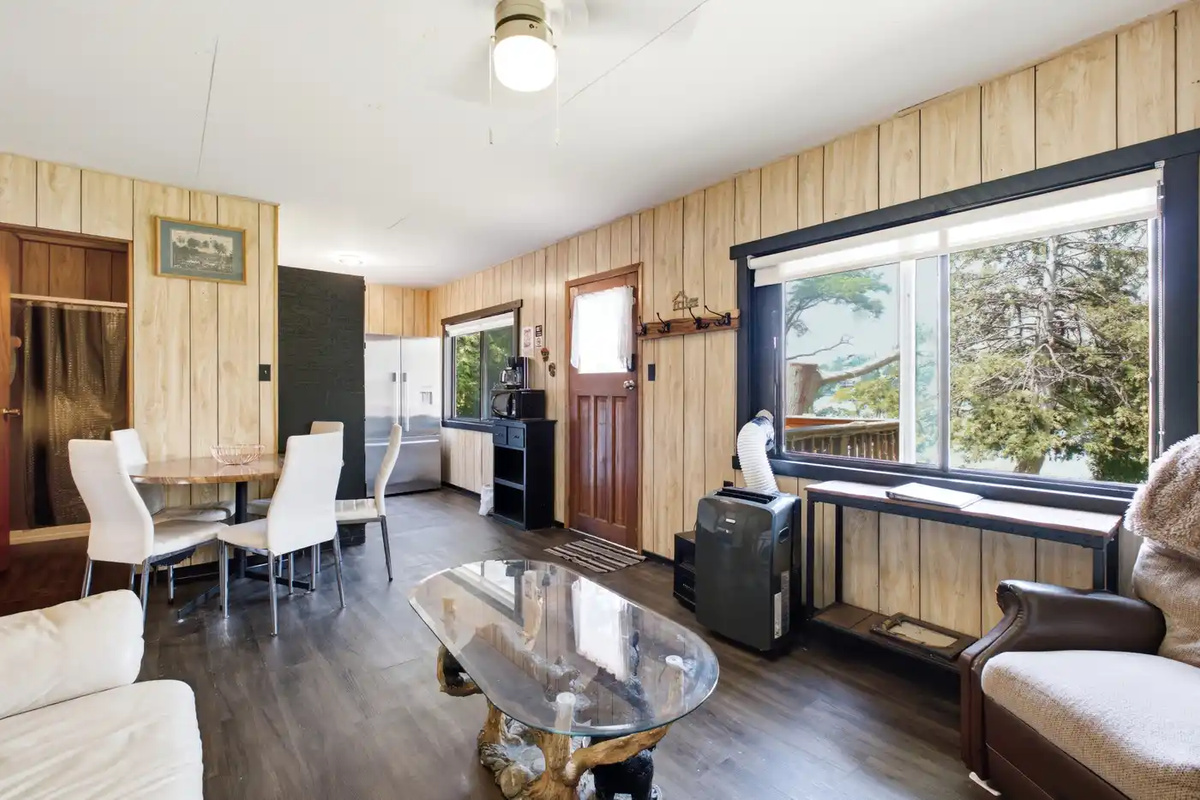 Bright living and dining area with large windows