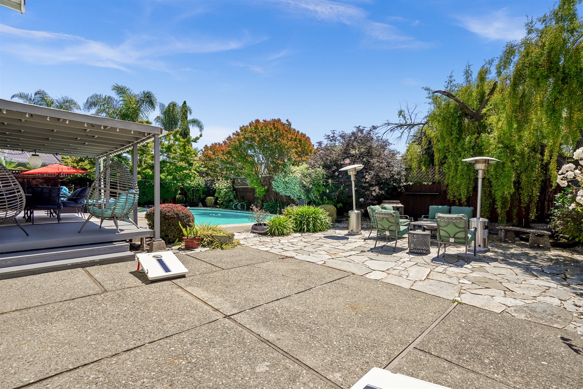 Private backyard retreat with a sparkling pool, outdoor seating, and space to relax and enjoy Napa Valley’s beautiful weather.