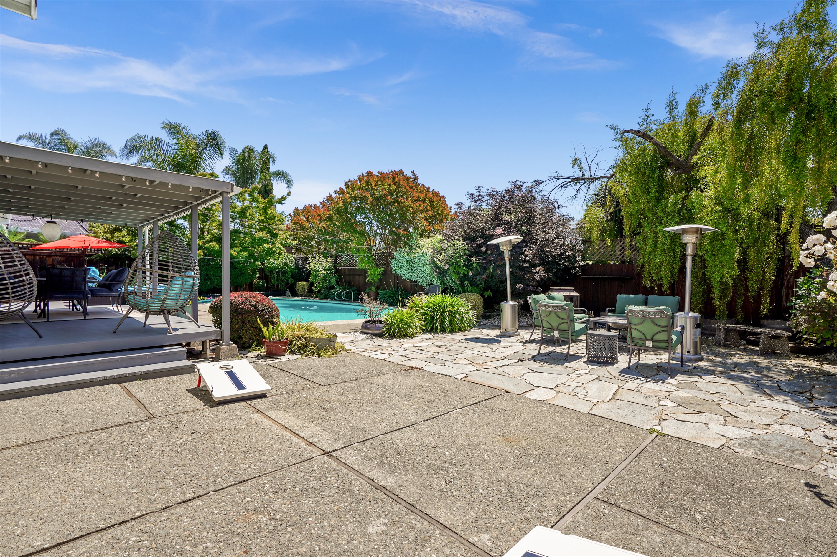 Private backyard retreat with a sparkling pool, outdoor seating, and space to relax and enjoy Napa Valley’s beautiful weather.