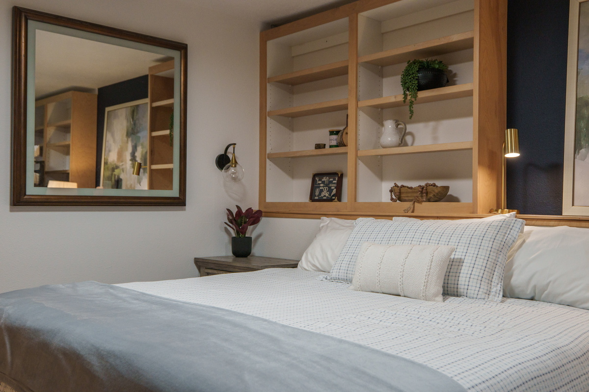 Bedroom 2 is thoughtfully designed for families and groups, featuring a queen bed, a queen-over-queen bunk bed, a dedicated remote-work desk, and a private ensuite bathroom (Bathroom 2)