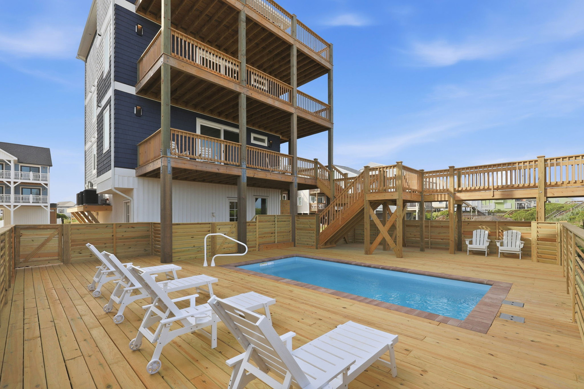 Exterior view of home with multi-level decks, stairs, and pool area