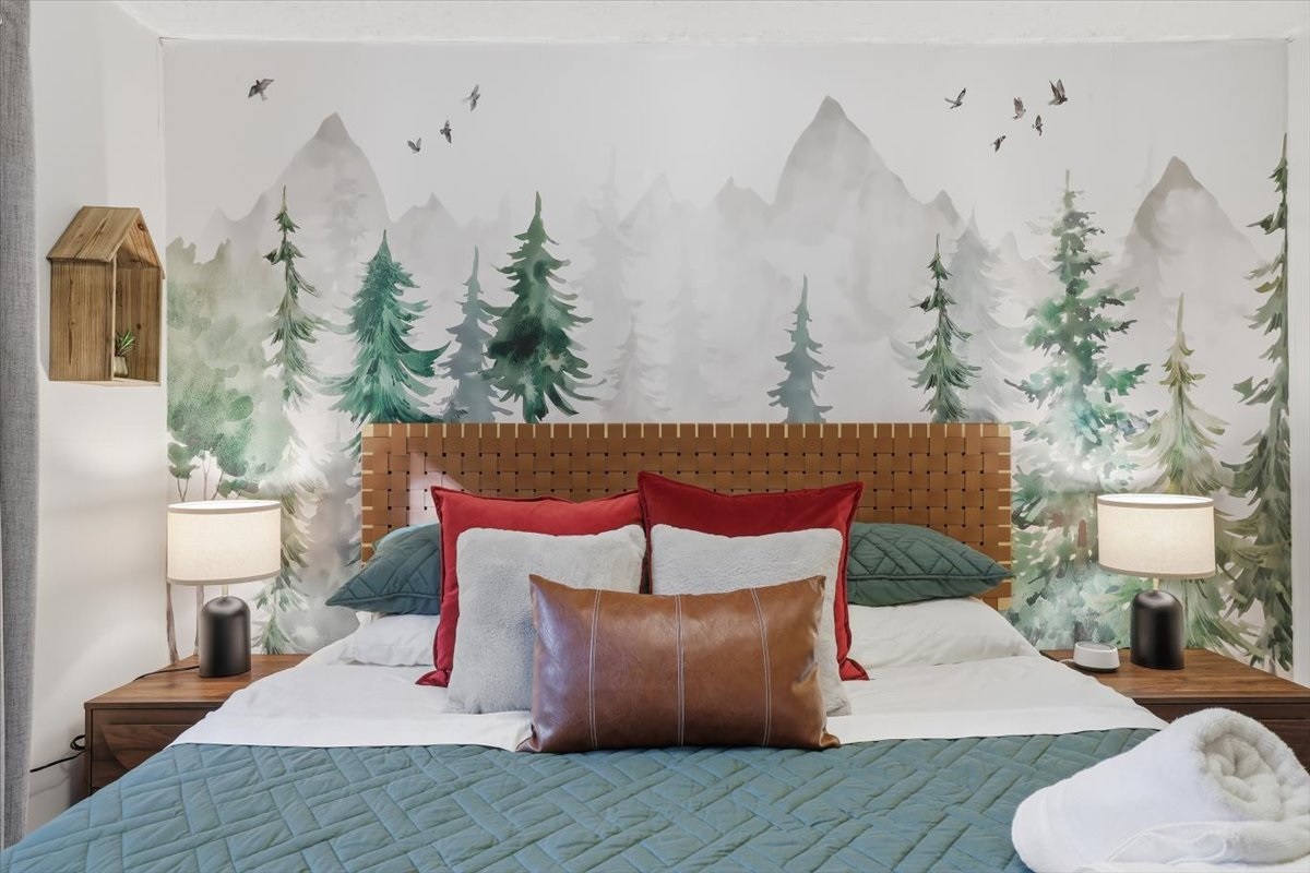 Drift off in this Poconos chalet surrounded by towering pines, even from the comfort of your bed