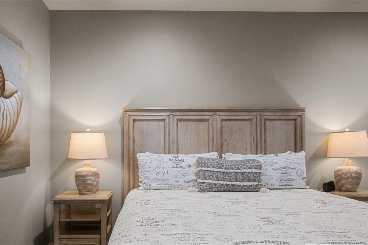 Bedroom with king bed, ceiling fan, TV and en-suite bathroom 