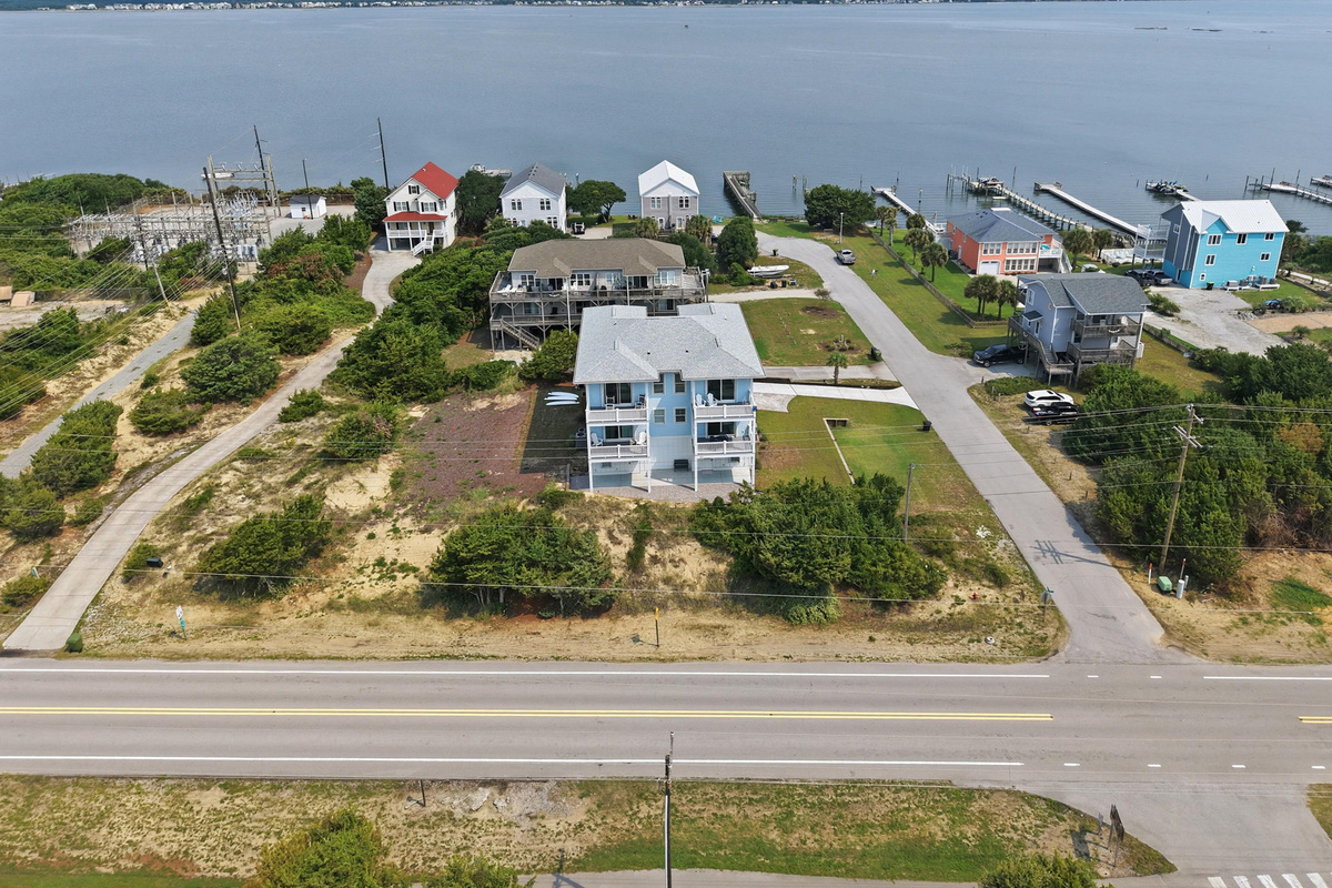Aerial view showcasing the home&rsquo;s unique coastal location between the sound and ocean, with nearby waterways and beach access