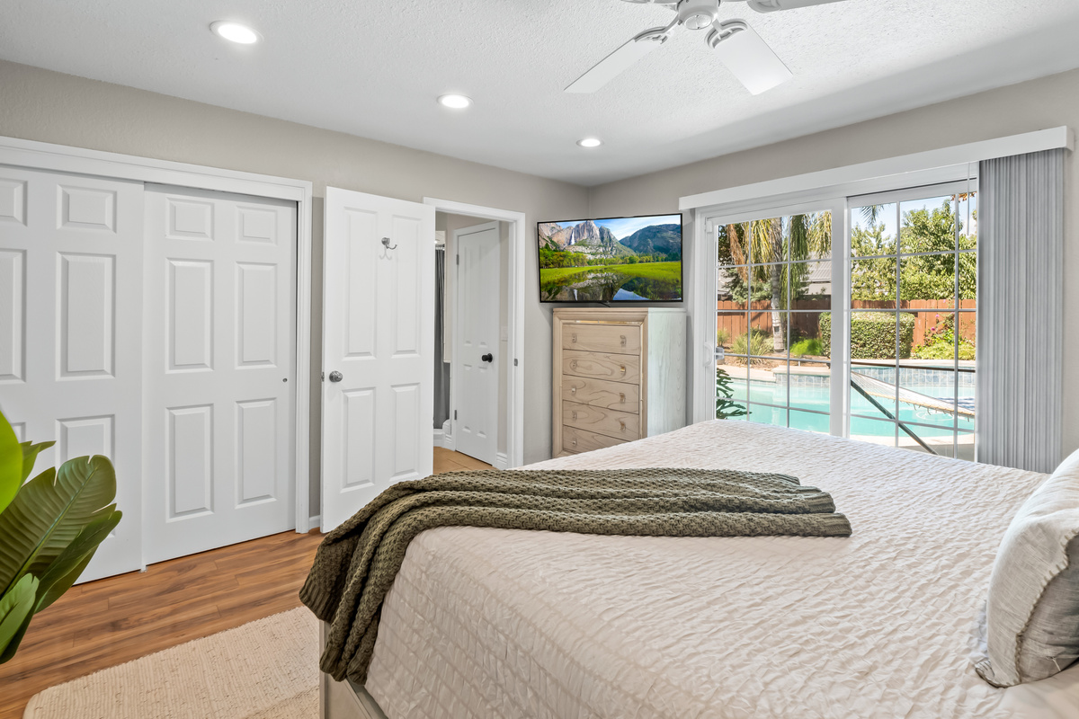 Wake up to a beautiful view of the backyard and pool from this bright, relaxing bedroom. With plenty of natural light and direct outdoor access, vacation mode is never far away.