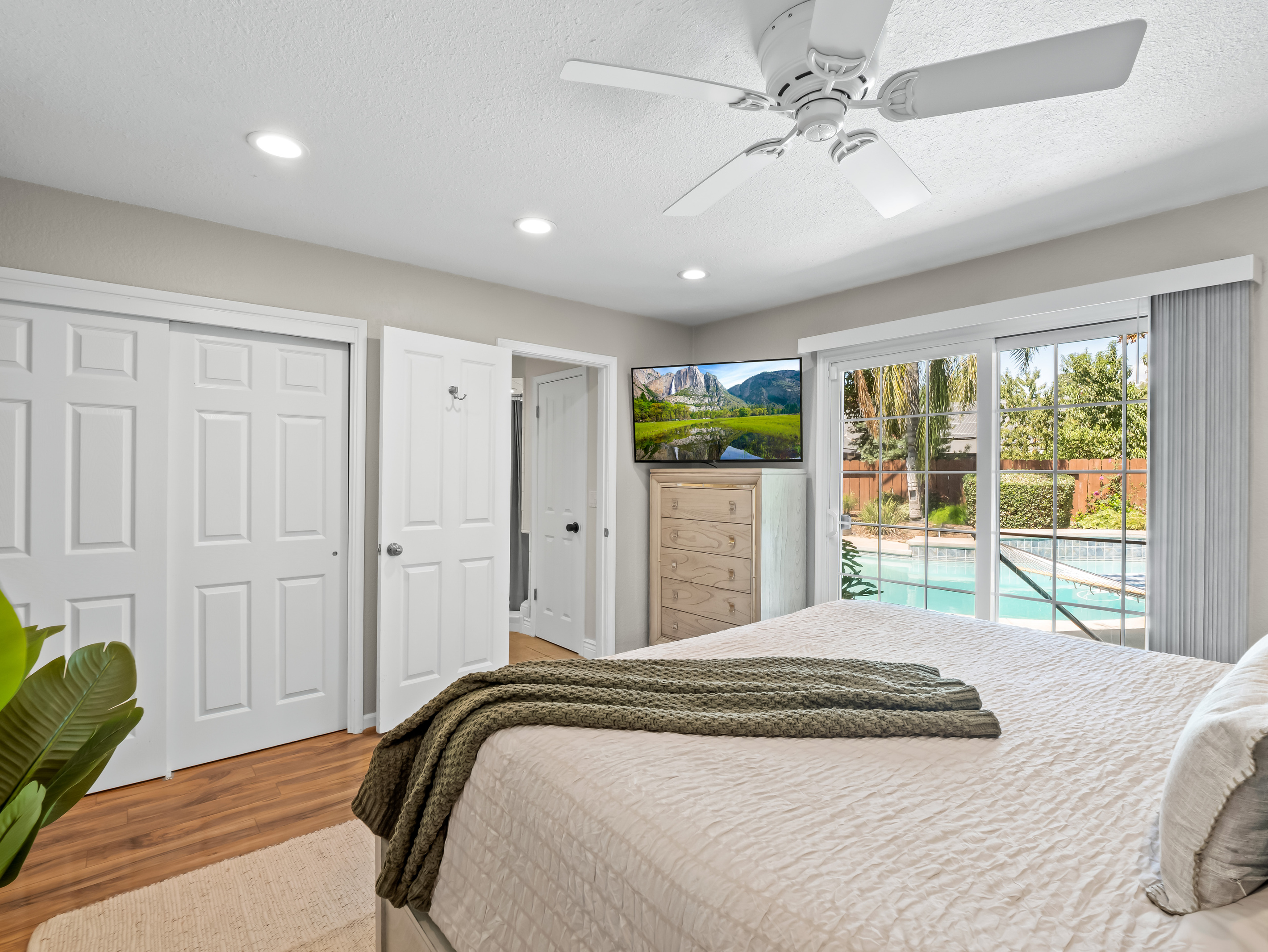 Wake up to a beautiful view of the backyard and pool from this bright, relaxing bedroom. With plenty of natural light and direct outdoor access, vacation mode is never far away.