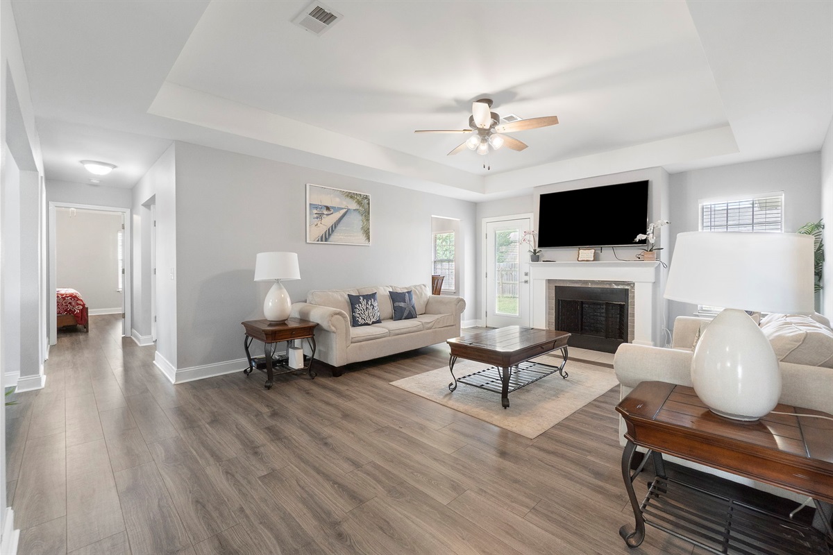 Anchored by a fireplace and TV, this inviting living area offers the ideal spot to gather with family or friends.