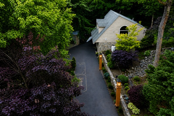 View of Guesthouse driveway and lush woodland garden