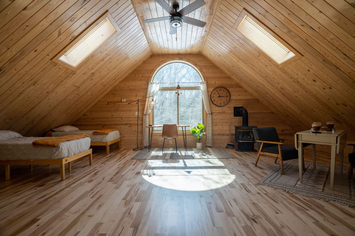 The second half of the upstairs living area features a desk in front of the window, two twin beds, a drop leaf table for games and the cozy gas fireplace.  