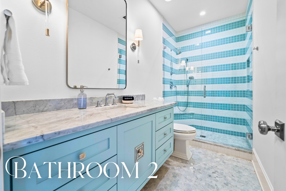 Spacious bathroom with beautiful blues and shower.