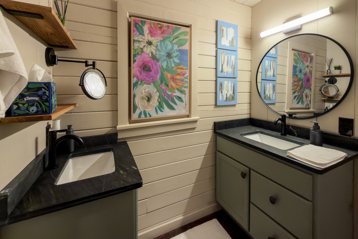 Bathroom vanity with colorful art.