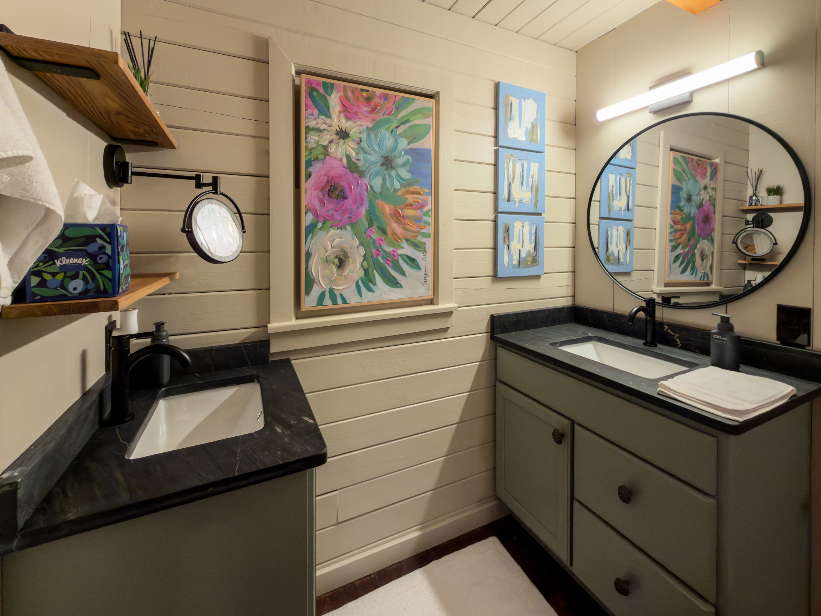Bathroom vanity with colorful art.