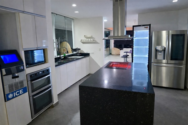 Full kitchen with ICE MAKER, 2 refrigerators, microwave, oven, and around 30 plates/bowls