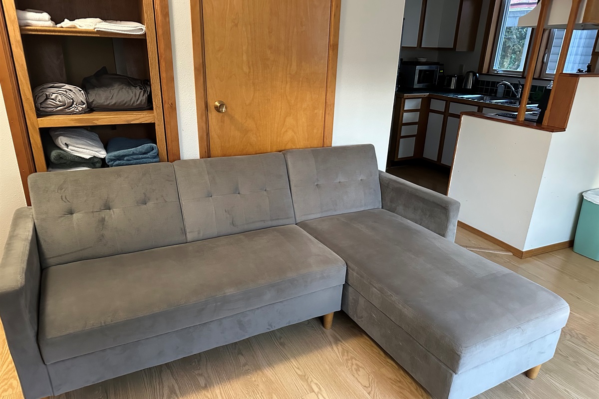 Relax in the cozy living area with a comfortable sofa.