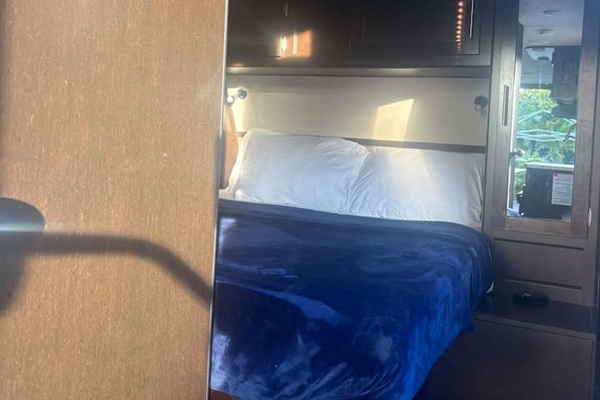 Bedroom - queen size bed with closets on each side. Place to charge phones and set deinks. Lights above bed for reading.