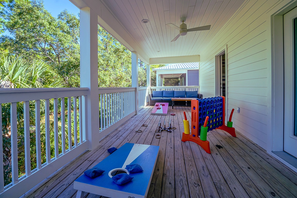 Spacious deck with seating areas, cornhole, and ring toss - perfect for outdoor fun and relaxing evenings