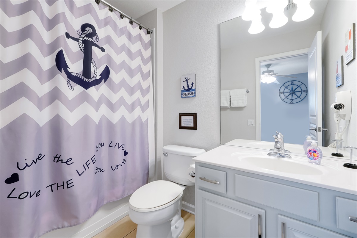 Blue upstairs bedroom has its own bath with tub