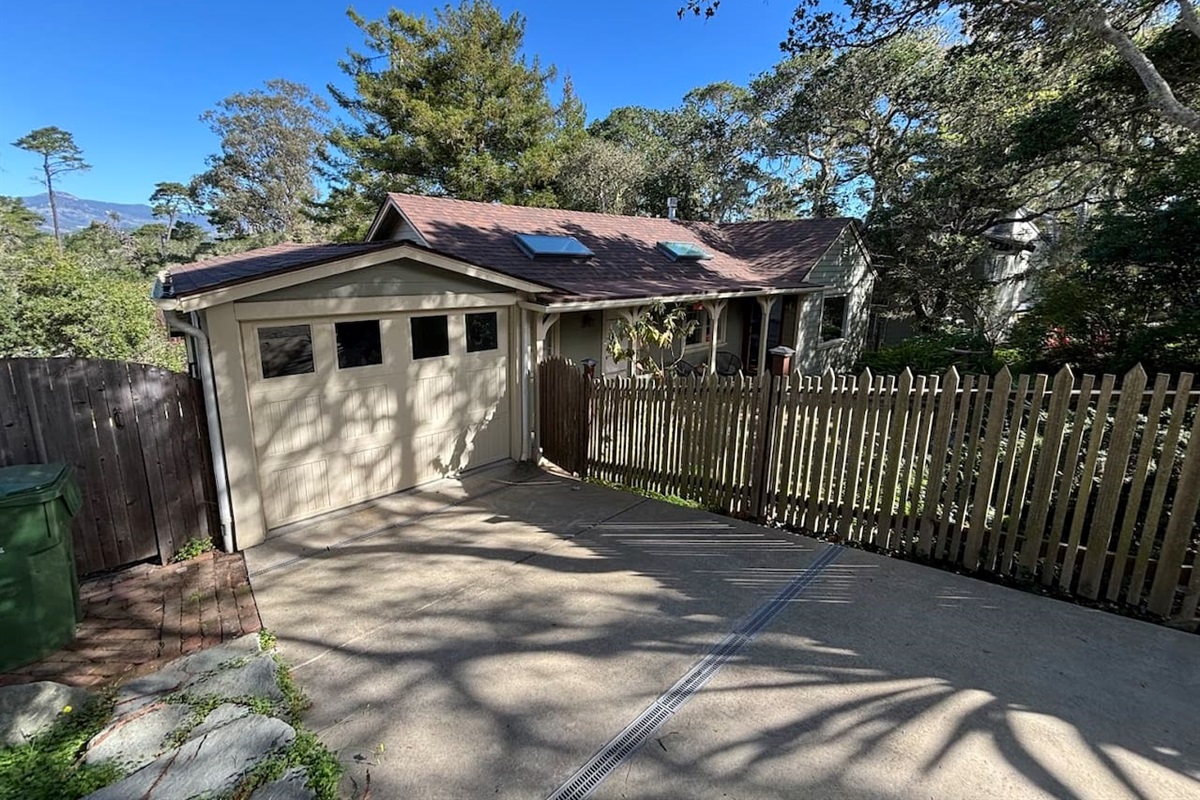 Down slope driveway, single car garage not accessed from interior of the house.