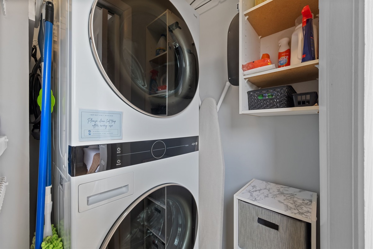 Full laundry setup with storage shelves, cleaning supplies, and everything you need for longer stays